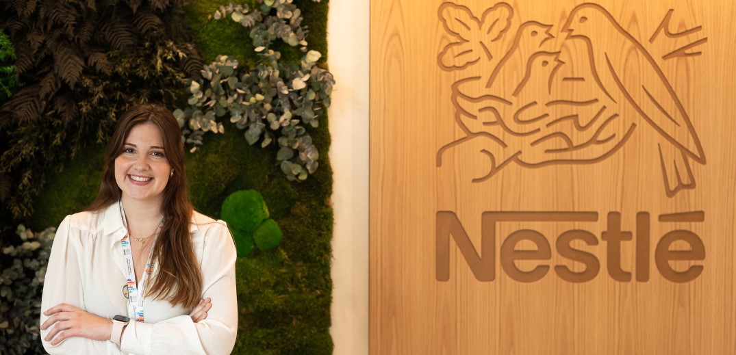 person in front of the Nestle banner
