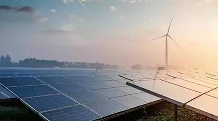 Solar panels with wind turbine in background  